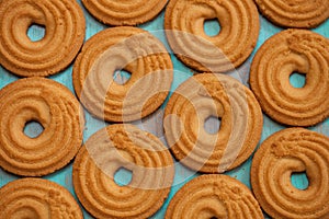 Pattern of butter cookies/biscuits on wooden teal green rustic background, flat lay design with butter cookies photo