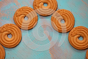 Pattern of butter cookies/biscuits on wooden teal green rustic background with space for text, flat lay design with butter cookies photo