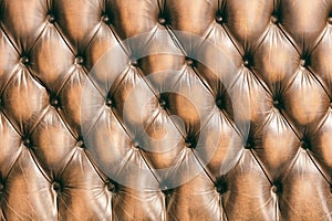 Pattern of chesterfield buttoned brown leather