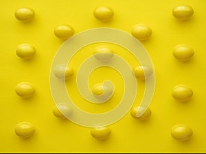 Pattern Of Chicken Eggs In Line Against Yellow Background