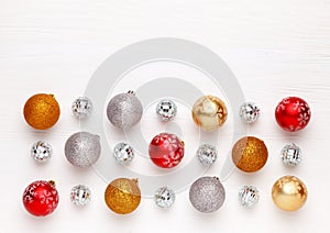 Pattern of Christmas toys colorful balls on white wooden background