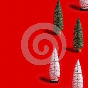 Pattern with Christmas tree white and green colors on red background. Minimal New Year layout with small festive fir