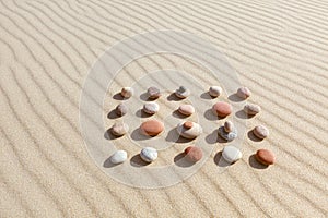 Pattern of colored pebbles on clean sand