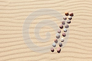 Pattern of colored pebbles on clean sand. Zen background, harmony and meditation concept