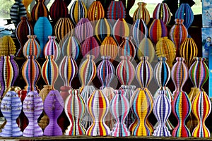 A pattern of colorful paper decorations on a shelf