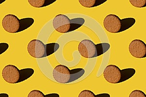 Pattern of cookies on a yellow background. Minimal trendy sunlight concept