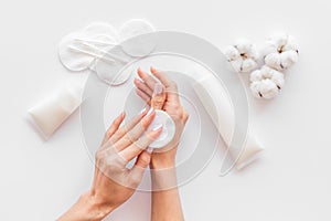 Pattern of cosmetic cotton pads and cream for hands on white background top view