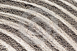 Pattern of curved lines on the sandy beach.