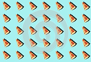 A pattern with a cut slice of pizza with a shadow on a turquoise background