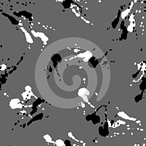 Pattern design with black and white stains on gray background.