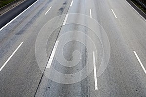 Pattern of empty highway in grea with median stripes