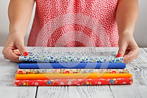 Pattern on fabrics and sewing accessories on a table