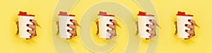 Pattern of female hand holding white paper mug on yellow background. Take away coffee cup concept. Mock up with copy space