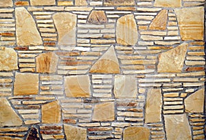 A pattern of flat stones. Grey stone wall background. Surface s