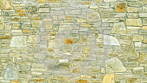 A pattern of flat stones. Grey stone wall background. Surface st