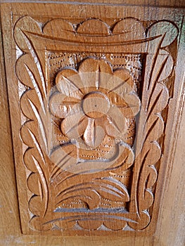 Pattern of flower carved on wood background. Old grunge wooden background.