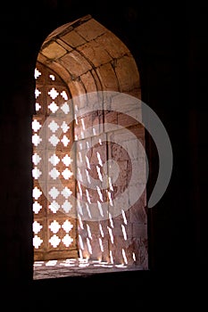 Pattern formed by sunlight passing through stone window grillwork at Jami Masjid in Mandu