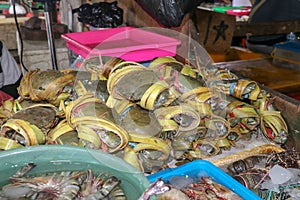 Pattern of fresh crabs selling on a seafood counter in Jimbaran. Pasar Ikan Kedonganan - Bali beach. Fresh crabs on the local fish