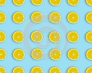 Pattern.Fresh lemon slices on a blue background.Flat lay, top view