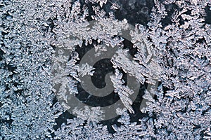 The pattern of frost on window glass in winter, hoarfrost, ice, macro, closeup,