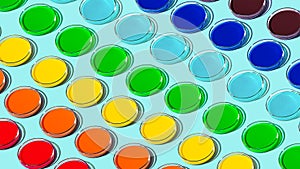 Pattern of glass petri dishes with rainbow colored liquid. Round glass jars of different colors. LGBT. Rainbow on a blue