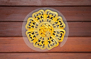 Pattern of gold flower carved on wood