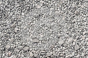 Pattern of gray and white gravel. The road surface is made of crushed stone and limestone