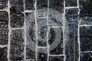 Pattern grey color of old stone wall uneven cracked real stone wall surface with cement