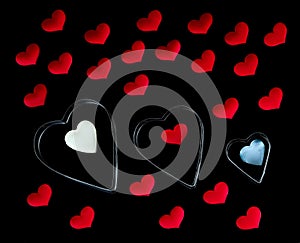 Pattern of hearts of different sizes and colors. Isolated on a black background