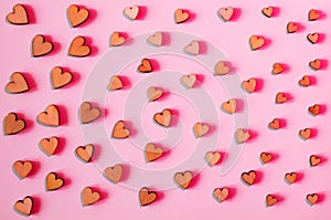 A pattern of hearts of different sizes on a pink background