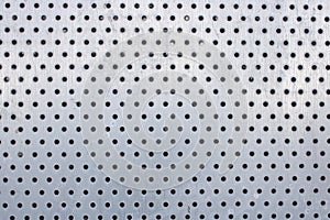 Pattern of holes on a silvery metal window shutter