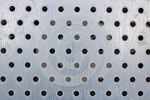 Pattern of holes on a silvery metal window shutter