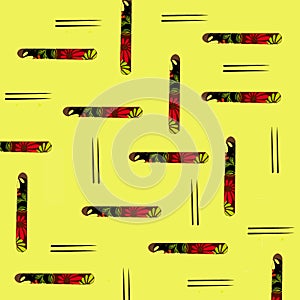 Pattern  with interesting objects, a pair of dark elegant Asian chopsticks and a small classic floral design box on yellow