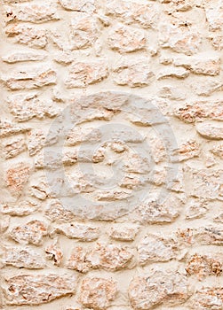 Pattern of light beige brown mediterranean stone wall texture
