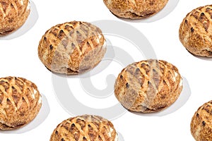 Pattern with loafs of freshly baked wheat bread on white background