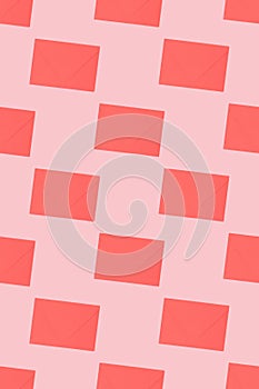 Pattern made of envelopes on a pink background.