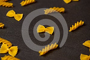 Pattern made of pasta on dark background.