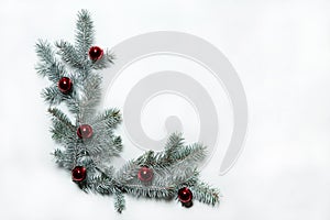 The pattern is made of spruce branches and red bells on a white background. Christmas, winter, New year.