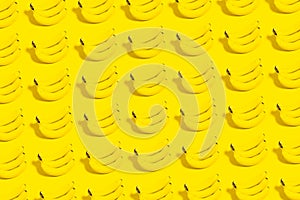 Pattern of many bananas on yellow background.