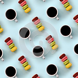 A pattern of many colorful dessert cake macaroon and coffee cups on trendy pastel blue background top view. Flat lay composition