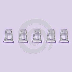 Pattern of many small shopping carts on a violet background. Minimalism flat lay top view