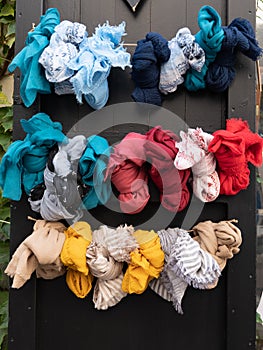 Pattern of many women scarves colorful vibrant colors shop hanging on display in shopping street market store