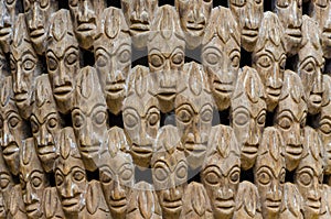 Pattern of many wood carved heads on chair at traditional Fon`s palace in Bafut, Cameroon, Africa photo