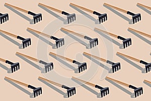 Pattern with metal rake isolated on light brown background