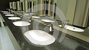 Pattern of modern bathroom sink and faucet in public toilet and restroom. Touchless taps. Virus protection concept. Sanitary rules