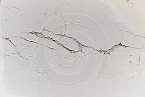 Pattern of paint peel off on plaster with scratches and cracks, texture vertical of wall. Scratched layer on surface of