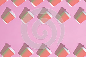 Pattern of paper cups on pink background