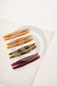 Pattern pastila fruit leather rolls up with fruits on white background. Vertically.