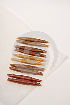 Pattern pastila fruit leather rolls up with fruits on white background. Vertically.