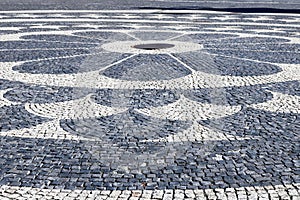 Pattern in paving stone with iron centre on Hviezdoslav Square near Slovak National Theatre, Bratislava, Slovakia